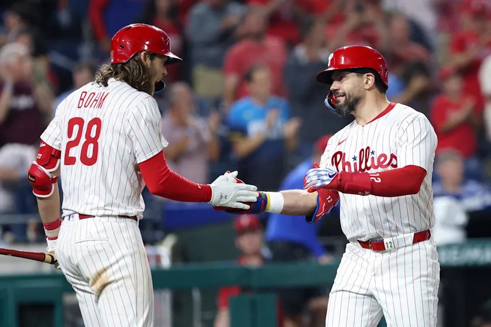 Sep 24, 2025; Philadelphia, Pennsylvania, USA; Philadelphia Phillies outfielder Kyle Schwarber (12) shakes hands with third base Alec Bohm (28) after hitting a home run against the Miami Marlins during the third inning at Citizens Bank Park. Mandatory Credit: Bill Streicher-Imagn Images