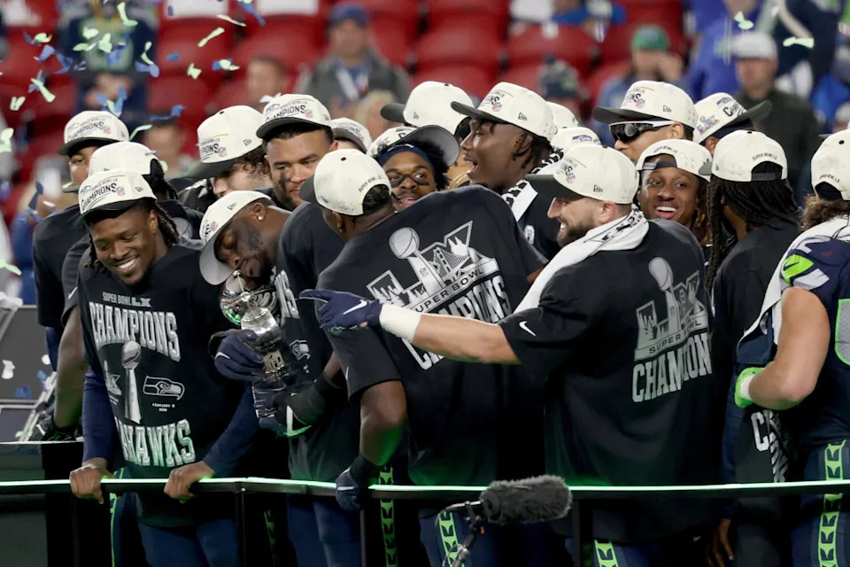 The Seattle Seahawks wear Fanatics T-shirts while celebrate beating the Patriots to win the Super Bowl.