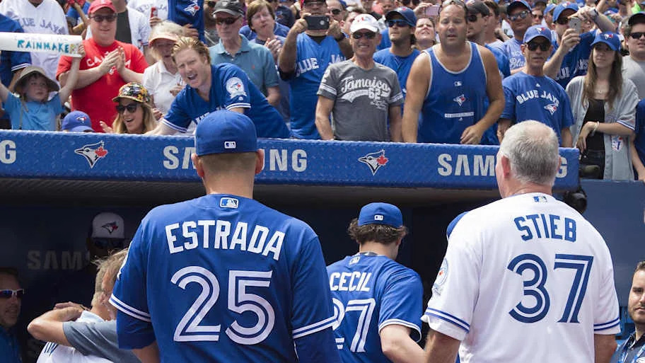 Toronto Blue Jays Dave Stieb standing in a jersey looking toward fans in the stadiu