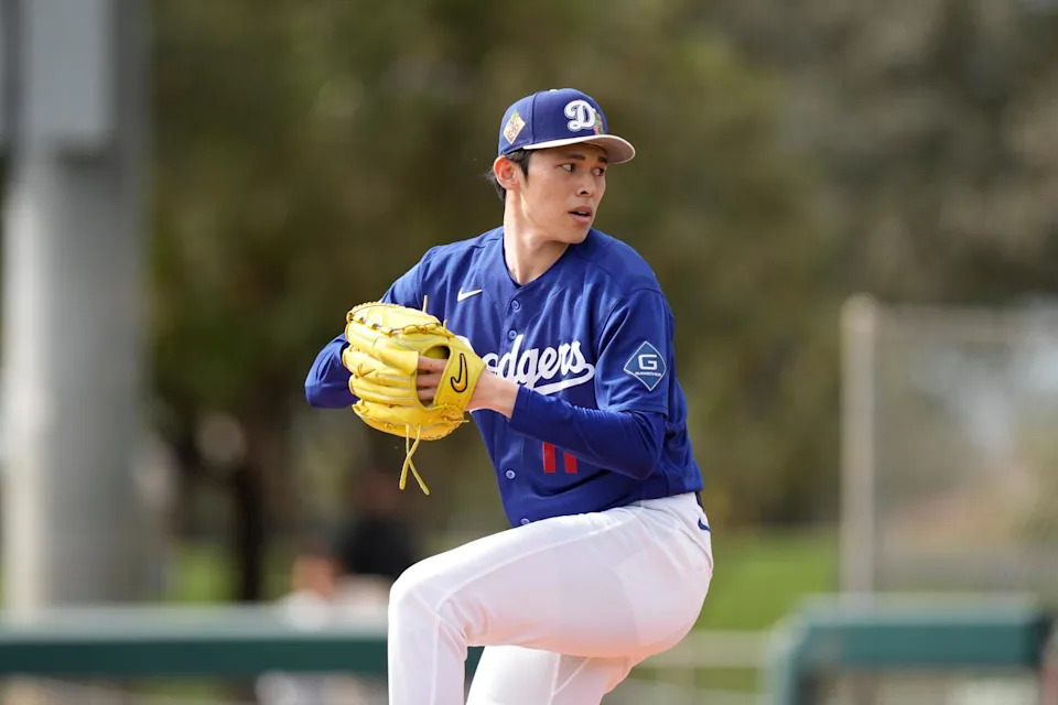 Dodgers pitcher Roki Sasaki throws during a spring training workout on Sunday at Camelback Ranch.