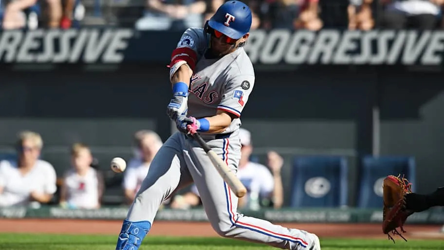 Texas Rangers left fielder Alejandro Osuna swings a bat to hit a baseball during a game.
