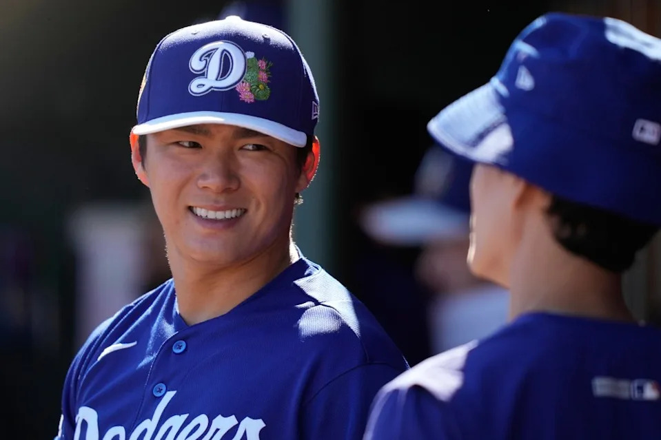 Los Angeles Dodgers pitcher Yoshinobu Yamamoto (18) laughs in the dugout during spring training baseball on Saturday, Feb. 21, 2026, in Tempe, Ariz. AP
