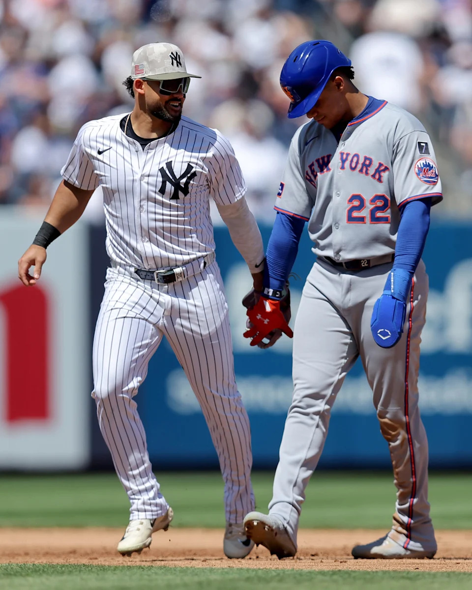 New York Yankees left fielder Jasson Dominguez (24) shakes hands with New York Mets right fielder Juan Soto (22) after the top of the fifth inning at Yankee Stadium.