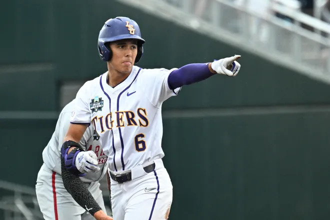 Jun 18, 2025; Omaha, Neb, USA; LSU Tigers left fielder Derek Curiel (6) points to the dugout after hitting a double against the Arkansas Razorbacks during the first inning at Charles Schwab Field. Mandatory Credit: Steven Branscombe-Imagn Images