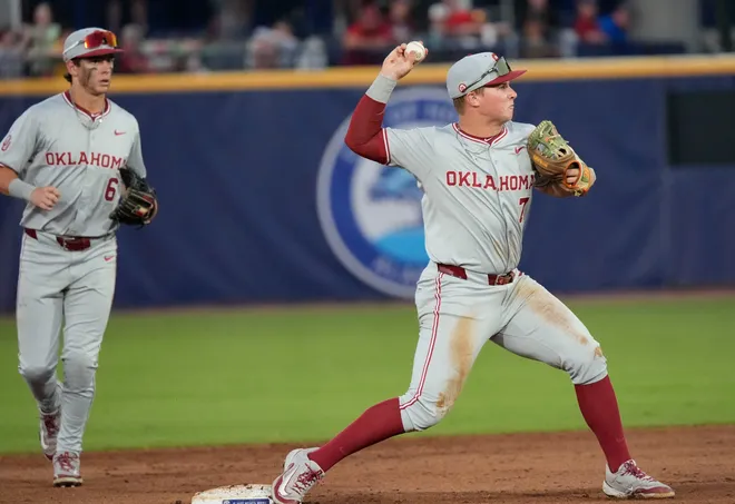 May 21, 2025; Hoover, AL, USA; Oklahoma shortstop Jaxon Willits (7) tuns a double play after fielding the ball and stepping on second to force out a Georgia runner in the second round of the SEC Baseball Tournament at the Hoover Met.