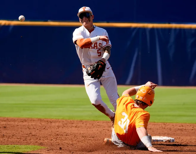May 22, 2025; Hoover, AL, USA; Texas infielder Ethan Mendoza (5) makes the turn on a double play after forcing out Tennessee designated hitter Levi Clark (30) in the third round of the SEC Baseball Tournament at the Hoover Met.