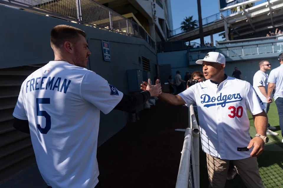 Dave Roberts and Freddie Freeman shake hands during DodgerFest at Dodger Stadium on Jan. 31, 2026. AP