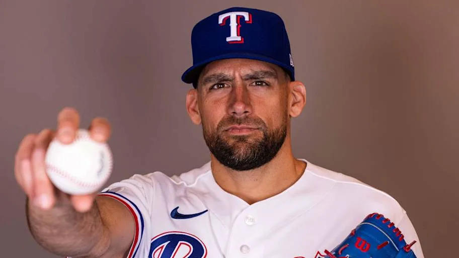 Texas Rangers pitcher Nathan Eovaldi points a baseball at a camera.
