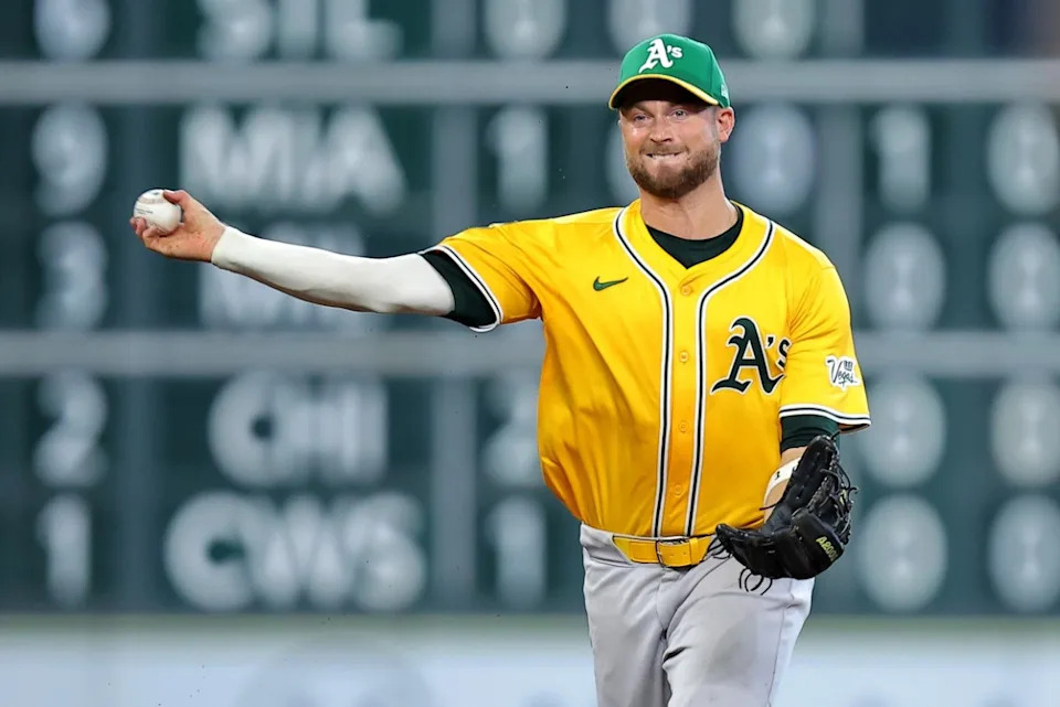 Athletics shortstop Max Schuemann (12) throws to first for an out against the Houston Astros during the seventh inning at Daikin Park.