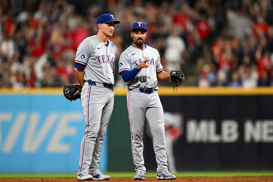 Marcus Semien #2 of the Texas Rangers talks with Corey Seager #5 against the Cleveland Guardians. Diamond Images/Getty Images
