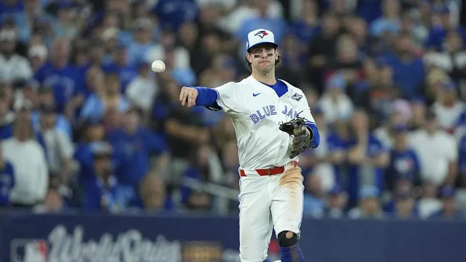 Toronto Blue Jays third baseman Ernie Clement (22) throws to first.