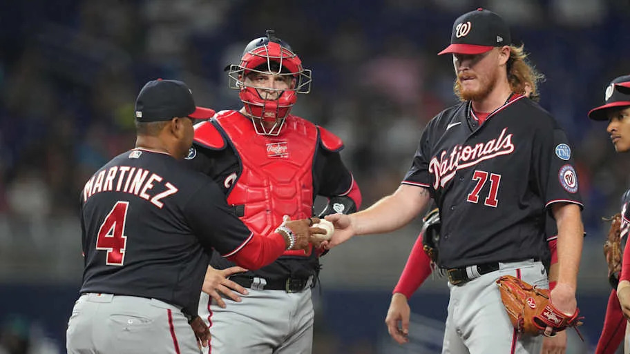 Washington Nationals relief pitcher Mason Thompson (71) gives the ball to manager Dave Martinez. 