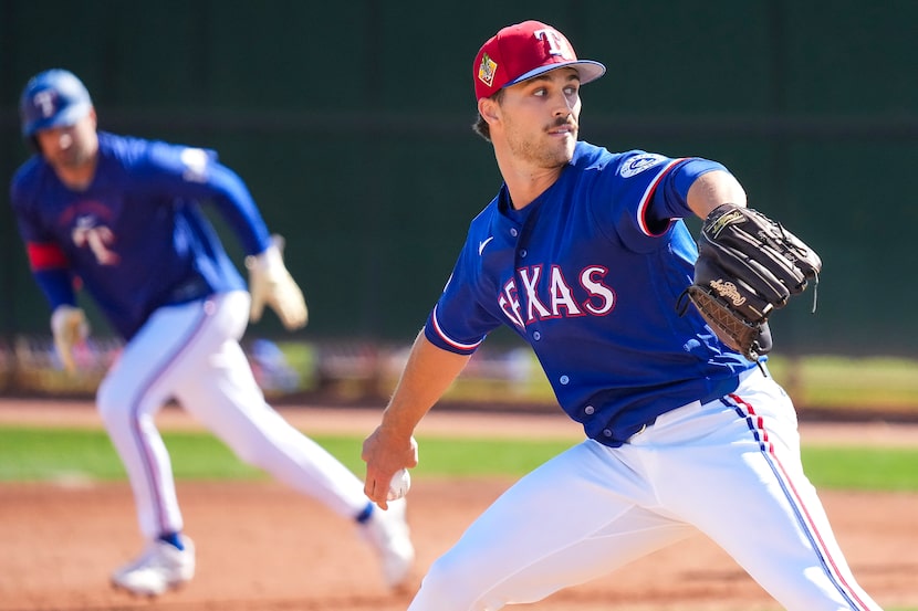 Texas Rangers pitcher Carter Baumler throws live batting practice during a spring training...