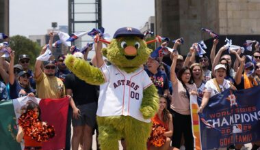 Houston Astros team mascot Orbit and fans, pose for a photo backdropped by the Monument to the Revolution in Mexico City, Thursday, April 25, 2024.(AP Photo/Fernando Llano)
