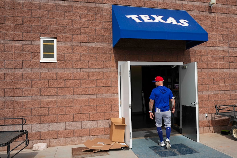Texas Rangers manager Skip Schumaker heads for the clubhouse after a spring training workout...