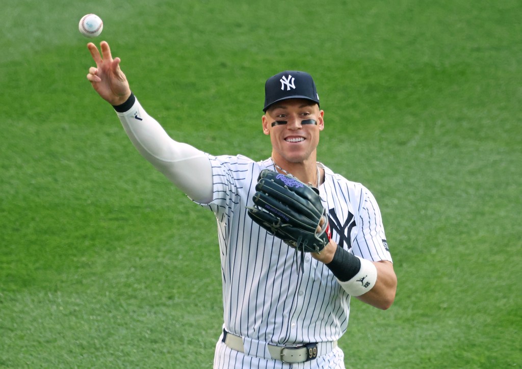 Aaron Judge throws a ball to fan during a Yankees home game against the Orioles last season.