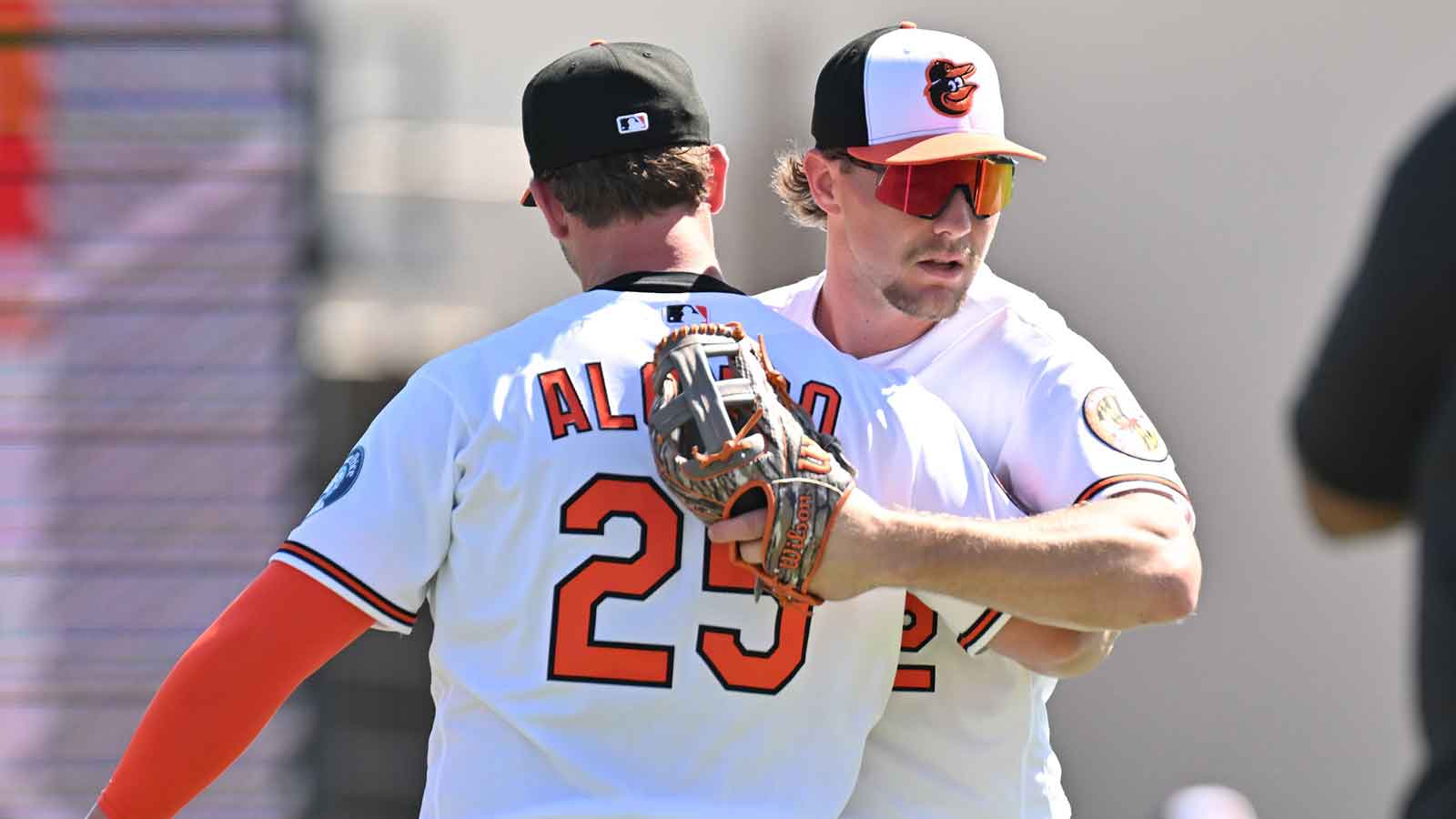 Baltimore Orioles first baseman Pete Alonso (25) greets shortstop Gunnar Henderson (2) before the start of the spring training game against the New York Yankees at Ed Smith Stadium