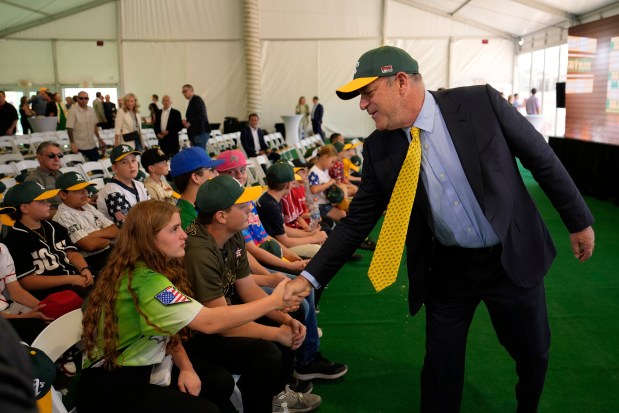 Athletics owner John Fisher, right, meets with people during a groundbreaking ceremony for the Athletics' baseball stadium Monday, June 23, 2025, in Las Vegas. (AP Photo/John Locher)