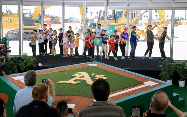 Athletics broadcaster Dallas Braden (C) looks on as Little League players throw toy baseballs to guests after singing the song "Take Me Out to the Ballgame" during a ceremonial groundbreaking for the USD 1.75 billion, 33,000-seat domed stadium for Major League Baseball's Athletics on June 23, 2025 in Las Vegas, Nevada. The ballpark is being built on nine acres of the 35-acre former site of the Tropicana Las Vegas, which was imploded in Oct. 2024. The A's expect to have the ballpark ready for Opening Day in 2028. (Photo by Ethan Miller/Getty Images)