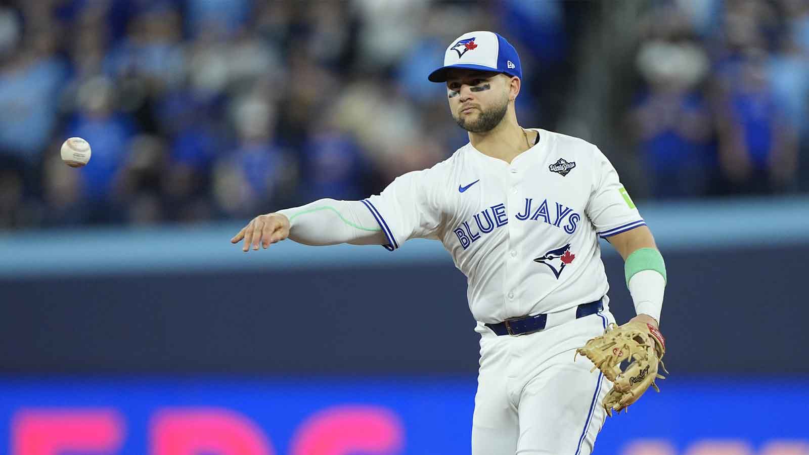 Toronto Blue Jays designated hitter Bo Bichette (11) throws to first for an out against Los Angeles Dodgers second baseman Tommy Edman (25) in the eighth inning during game seven of the 2025 MLB World Series at Rogers Centre. 