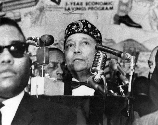 Elijah Muhammad addresses a crowd at the Coliseum on Feb. 26, 1965, in Chicago. In his speech, the head of the Black Muslims assailed Malcolm X, who was assassinated the previous week. (Chicago Tribune historical photo)
