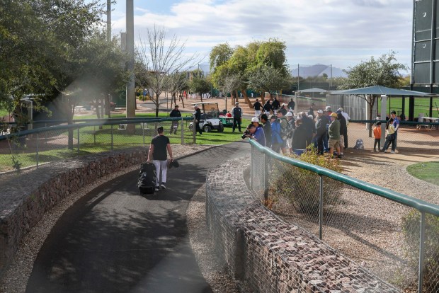 White Sox catcher Kyle Teel walks to the fields as fans stand near the fence during spring training at Camelback Ranch on Feb. 18, 2026, in Glendale, Ariz. (Eileen T. Meslar/Chicago Tribune)