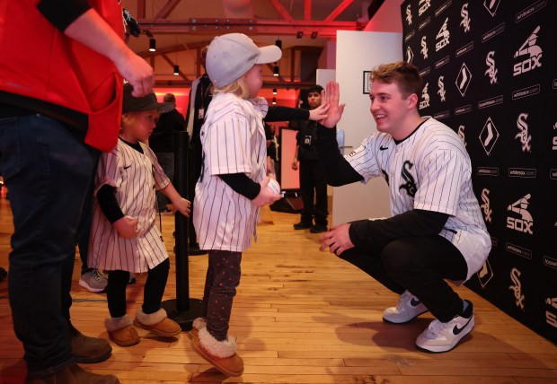 Chicago White Sox catcher Kyle Teel receives a high-five from a young fan during SoxFest at the Ramova Theatre in Chicago's Bridgeport neighborhood on Friday, Jan. 30, 2026. (Chris Sweda/Chicago Tribune)