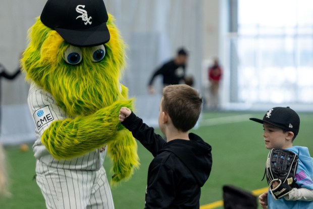 Southpaw fist bumps a young baseball player during the Chicago White Sox SoxFest Kids Camp Saturday, Jan. 31, 2026, at the ComEd Recreation Center at Addams Park in Chicago. The event allowed kids to learn baseball from youth academy coaches and current White Sox players and prospects. (Josh Boland/Chicago Tribune)