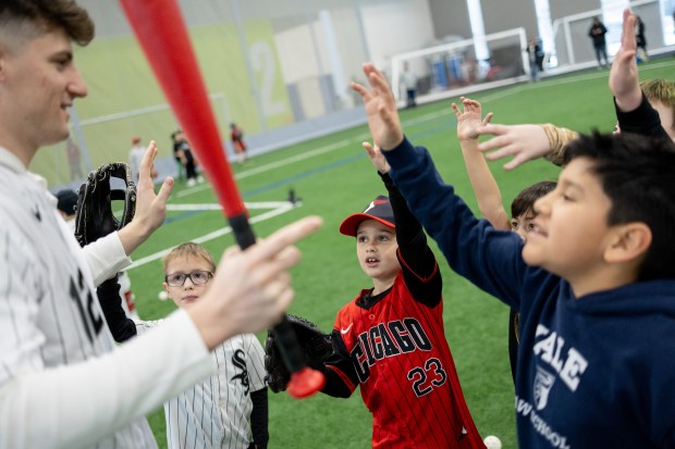 Chicago White Sox shortstop Colson Montgomery, left, chooses a volunteer from a group of young baseball players during the Chicago White Sox SoxFest Kids Camp Saturday, Jan. 31, 2026, at the ComEd Recreation Center at Addams Park in Chicago. The event allowed kids to learn baseball from youth academy coaches and current White Sox players and prospects. (Josh Boland/Chicago Tribune)