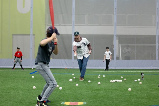 Chicago White Sox pitcher Shane Smith, tosses a ball to a young baseball player during the SoxFest Kids Camp Saturday, Jan. 31, 2026, at the ComEd Recreation Center at Addams Park in Chicago. (Josh Boland/Chicago Tribune)