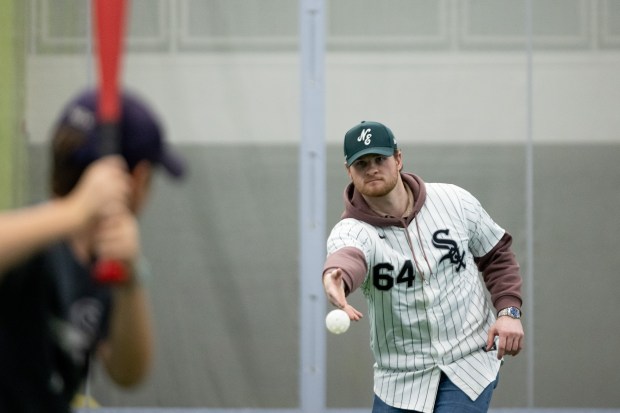 White Sox pitcher Shane Smith tosses a ball to a young player during SoxFest Kids Camp at the ComEd Recreation Center at Addams Park in Chicago on Saturday, Jan. 31, 2026. (Josh Boland/Chicago Tribune)