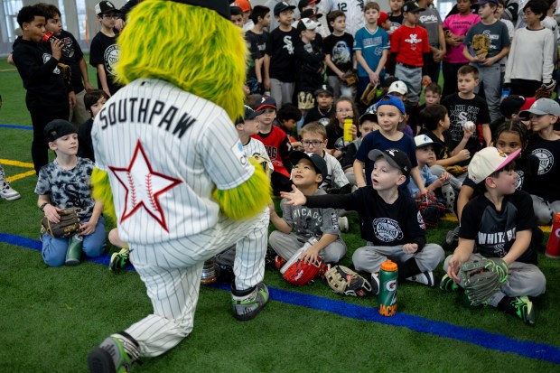 Southpaw high fives young baseball players during the Chicago White Sox SoxFest Kids Camp Saturday, Jan. 31, 2026, at the ComEd Recreation Center at Addams Park in Chicago. The event allowed kids to learn baseball from youth academy coaches and current White Sox players and prospects. (Josh Boland/Chicago Tribune)