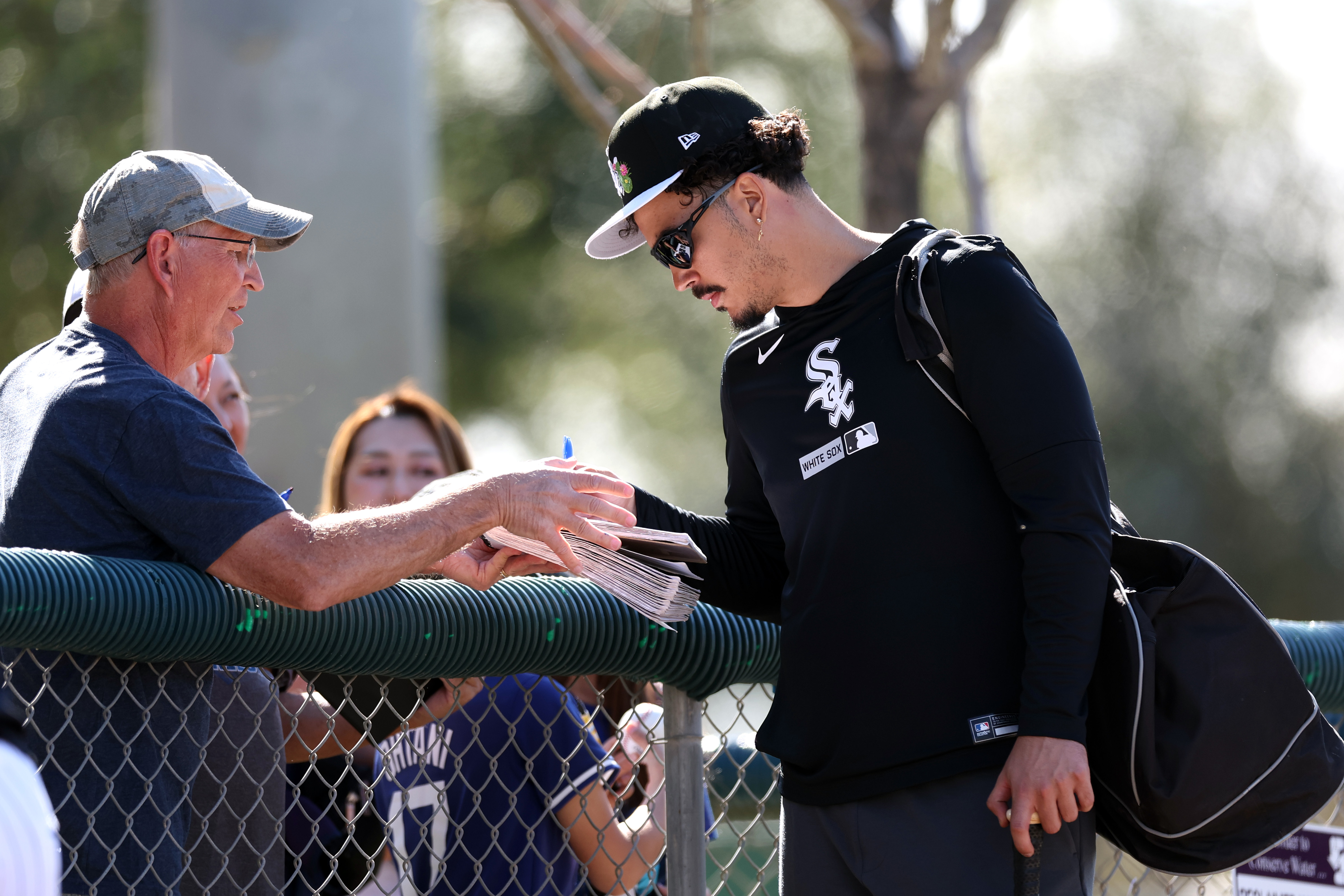 White Sox third baseman Miguel Vargas signs an autograph for...