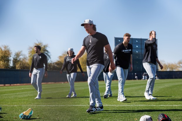 White Sox pitcher Hagen Smith, center, walks with other pitchers after running during spring training at Camelback Ranch on Feb. 15, 2025, in Glendale, Ariz.(Armando L. Sanchez/Chicago Tribune)