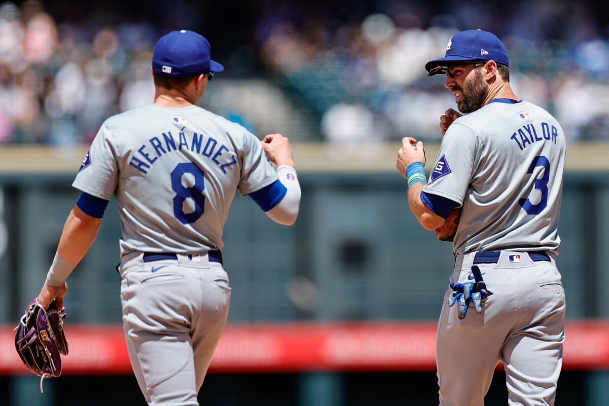 Los Angeles Dodgers third baseman Kike Hernandez (8) and second baseman Chris Taylor (3) in the fifth inning against the Colorado Rockies at Coors Field.