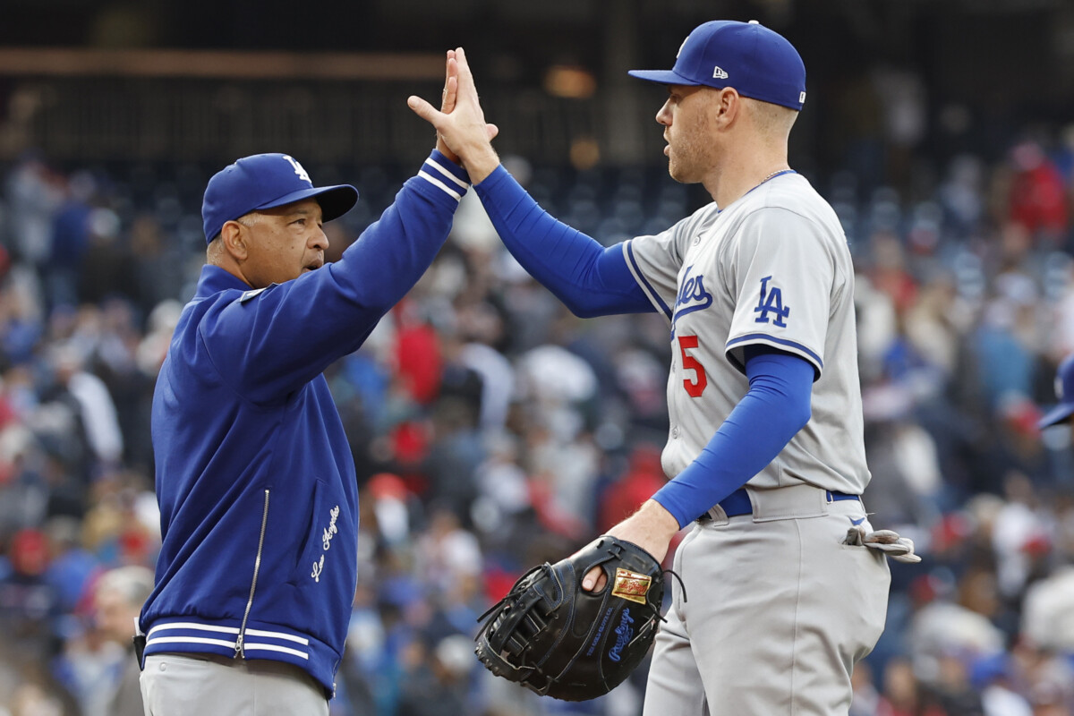 Los Angeles Dodgers manager Dave Roberts (30) celebrates with Dodgers first baseman Freddie Freeman (5) after their game against the Washington Nationals at Nationals Park.