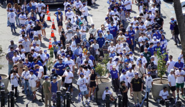 Fans wait in line to receive a bobblehead of Los Angeles Dodgers player Shohei Ohtani before the game against the Cincinnati Reds at Dodger Stadium.