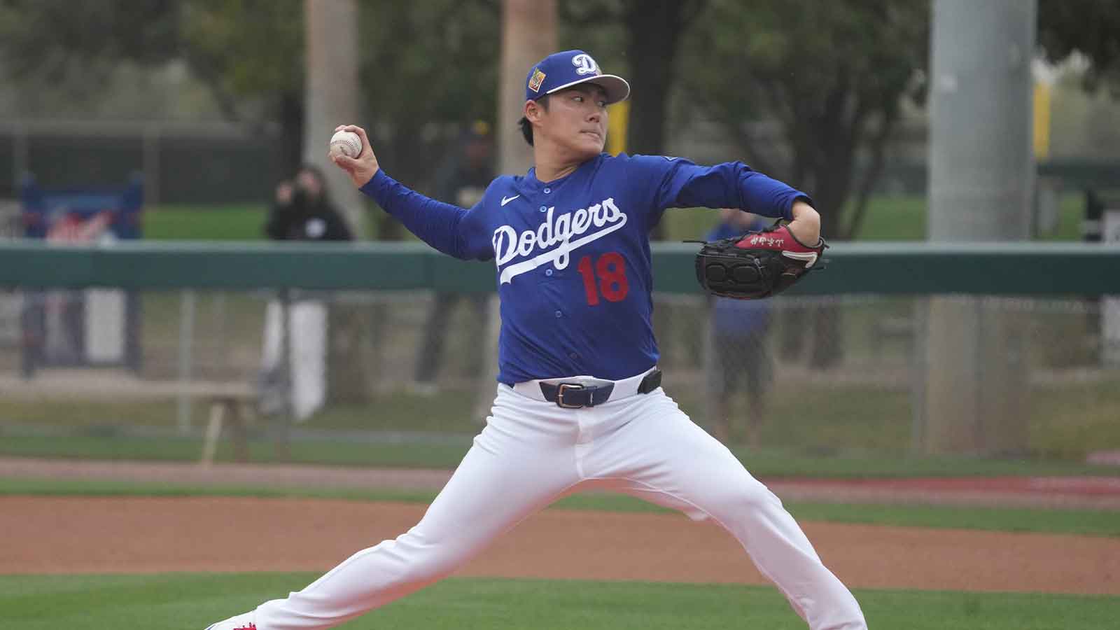 Los Angeles Dodgers pitcher Yoshinobu Yamamoto (18) throws from the mound during spring training camp.