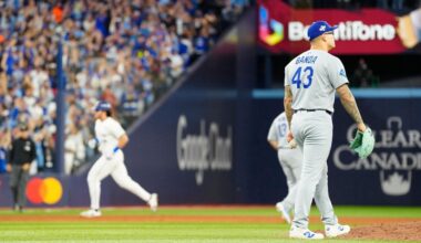 Los Angeles Dodgers pitcher Anthony Banda (43) reacts as Toronto Blue Jays' Addison Barger, back left, rounds the bases after hitting a grand slam during the sixth inning of Game 1 of baseball's World Series in Toronto, Friday, Oct. 24, 2025. (Frank Gunn/The Canadian Press via AP)
