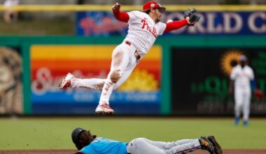 Philadelphia Phillies second baseman Bryson Stott flies over Miami Marlins third baseman Connor Norby as Norby steals second base during the second inning.