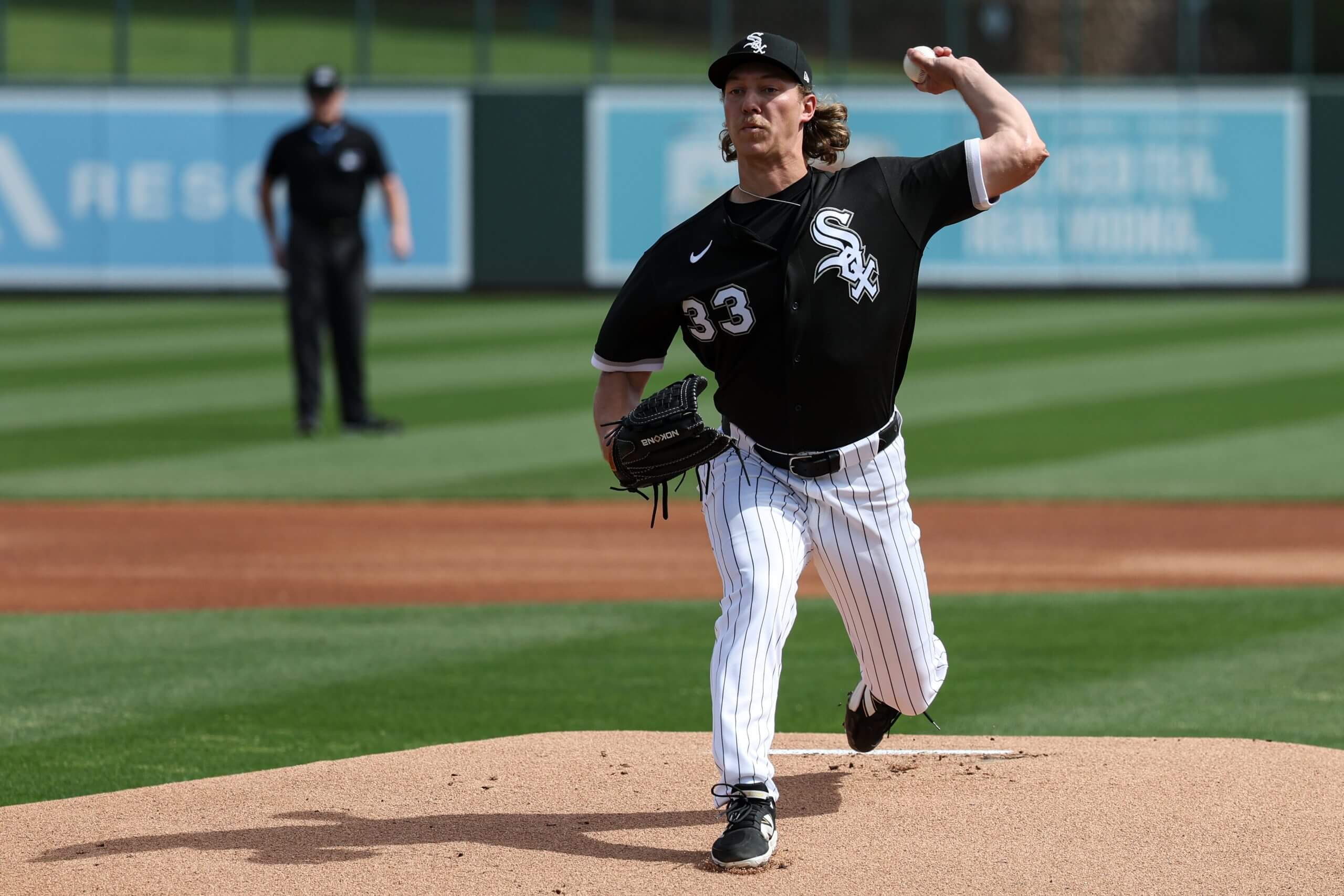 Hagen Smith of the Chicago White Sox, wearing No. 33 on his jersey, raises his arm to pitch during a game between the Rockies and the White Sox at Camelback Ranch. 