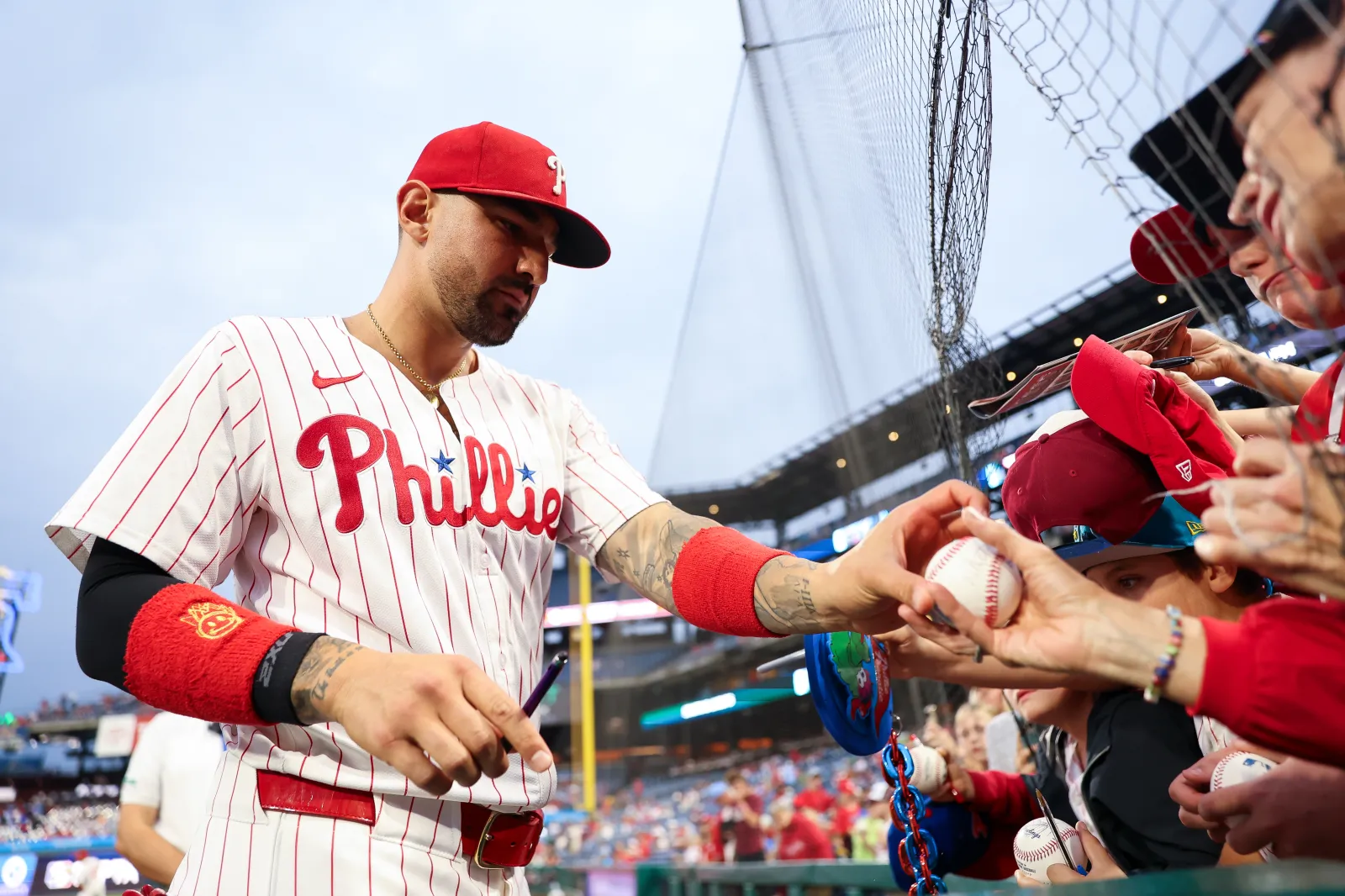 PHILADELPHIA, PENNSYLVANIA - SEPTEMBER 24: Nick Castellanos #8 of the Philadelphia Phillies signs autographs for kids before the game against the Miami Marlins at Citizens Bank Park on September 24, 2025 in Philadelphia, Pennsylvania. (Photo by Isaiah Vazquez/Getty Images)