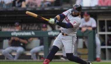 Cleveland Guardians' Carlos Santana hits a two-run double during the first inning of a baseball gam...