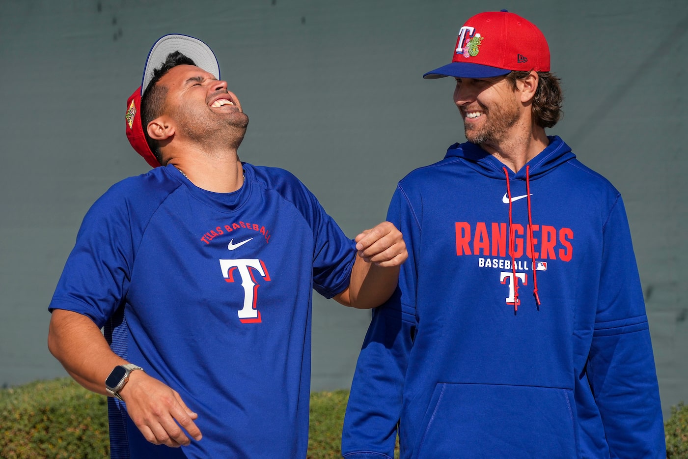 Texas Rangers pitcher MacKenzie Gore (left) laughs with pitcher Jacob Degrom as they head to...