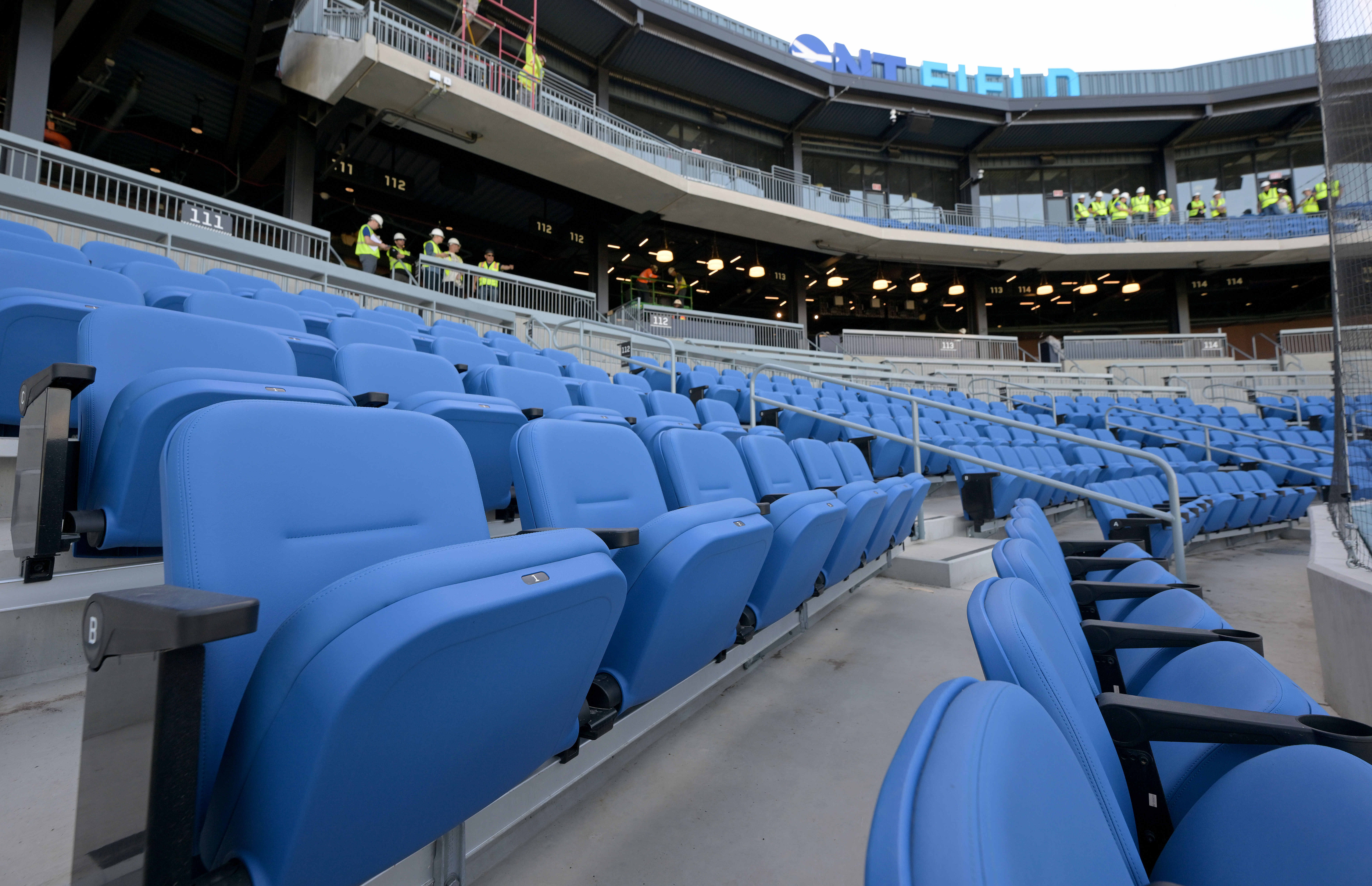Blue padded seats are seen Friday, Feb. 13, 2026, behind...