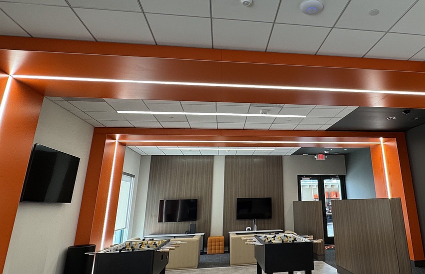 The orange-accented player lounge features foosball and ping-pong tables. The orange-accented player lounge features foosball and ping-pong tables.