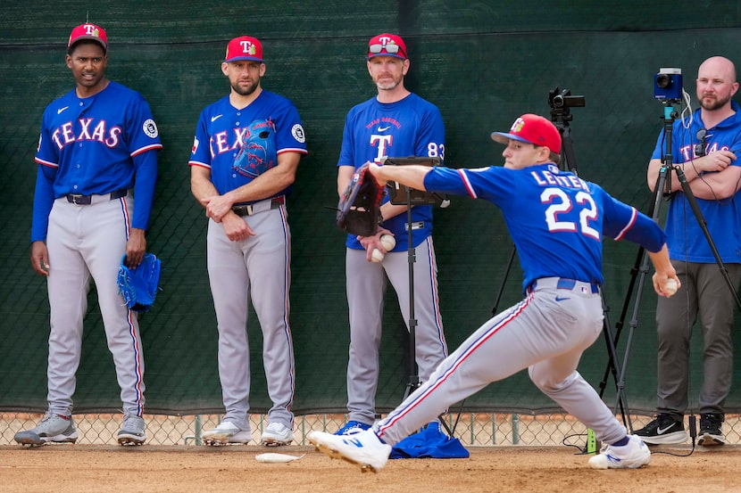 From left, Texas Rangers pitcher Kumar Rocker, pitcher Nathan Eovaldi and pitching coach...