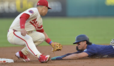 Josh Rojas #4 of the Seattle Mariners is caught stealing on tag by Keston Hiura #13 of the Los Angeles Angels in the second inning at Angel Stadium.