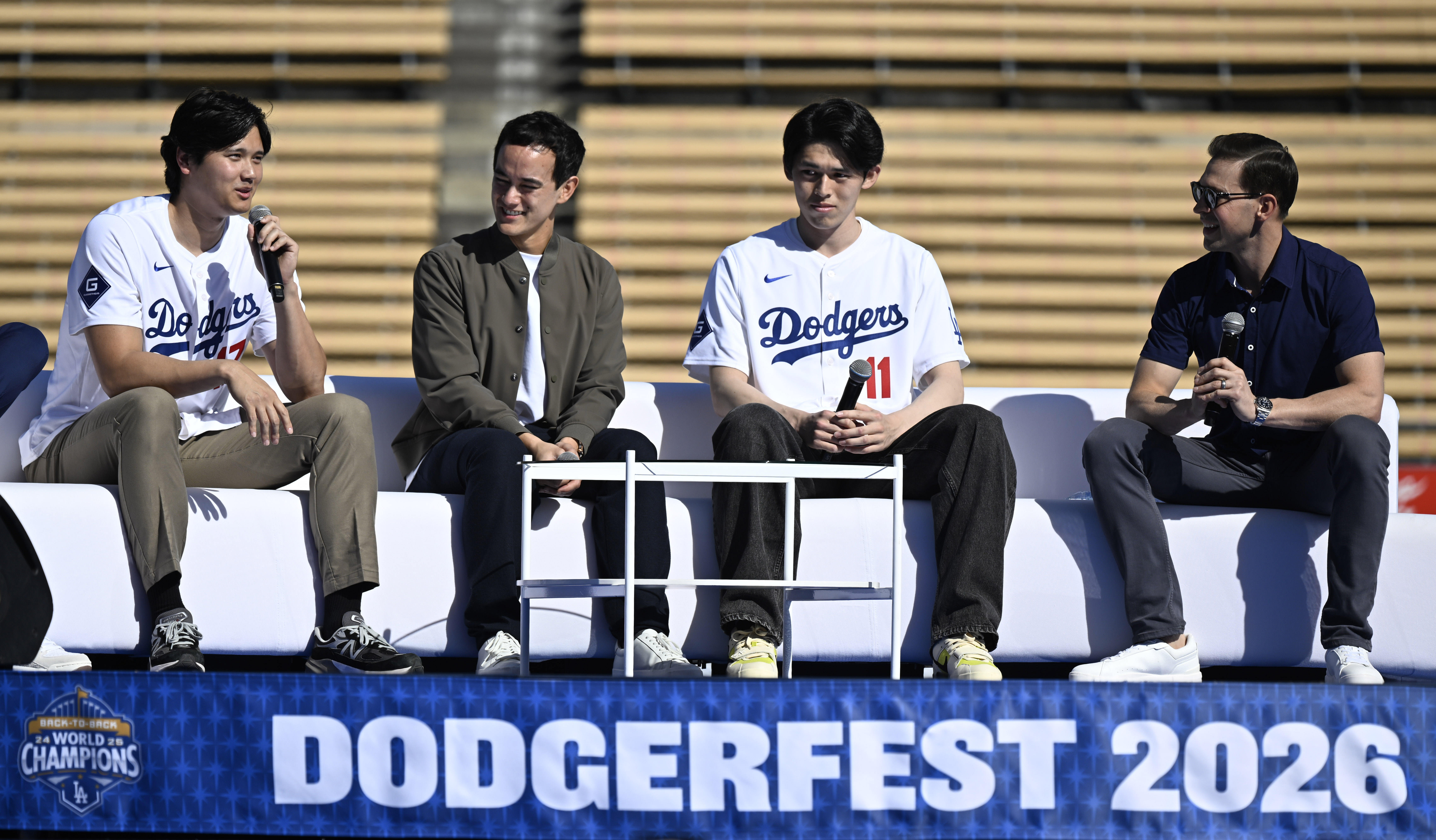 Shohei Ohtani, left, speaks as interpreter Will Ireton, pitcher Roki...