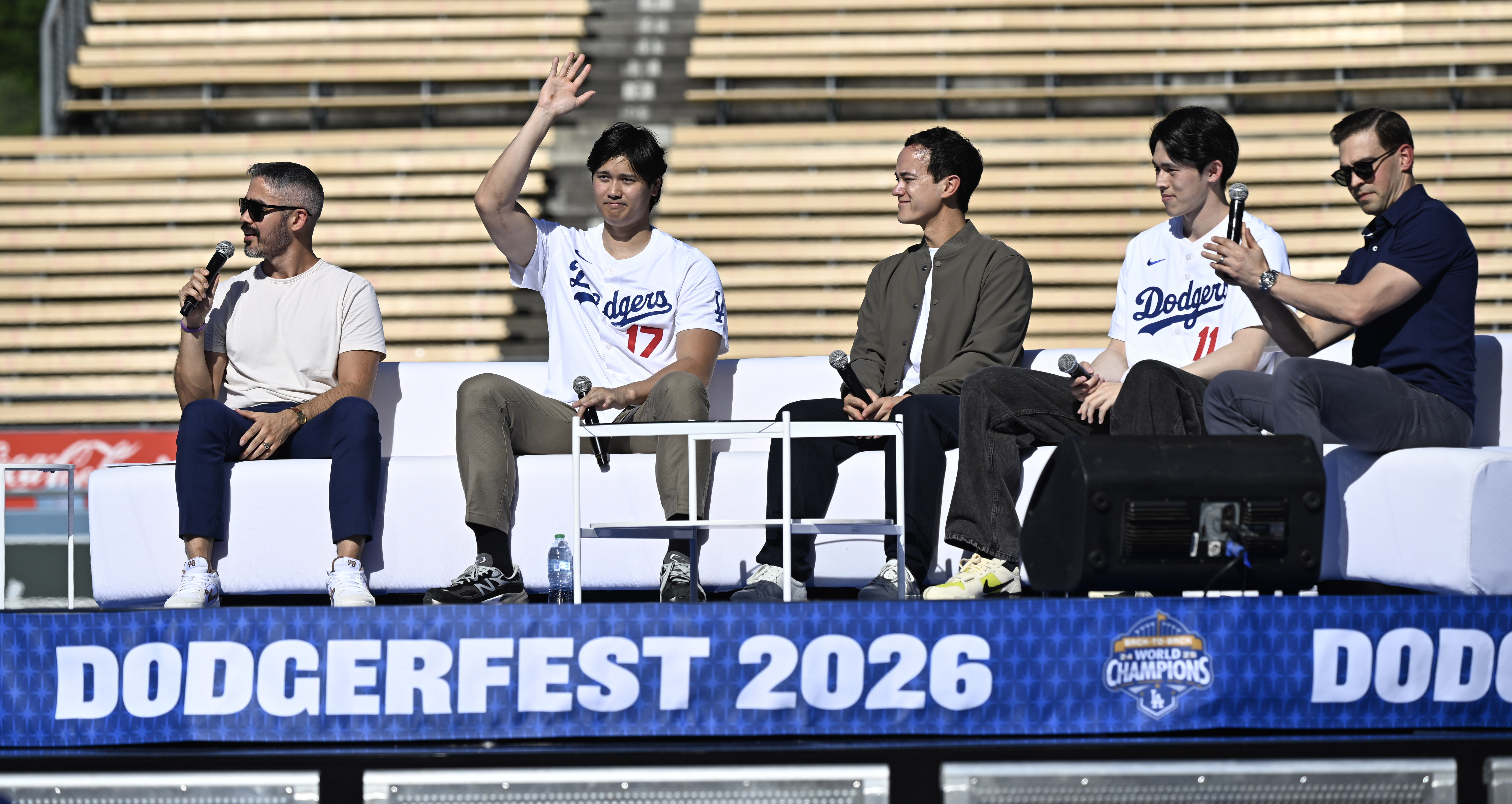 Shohei Ohtani, second from left, waves to the crowd as...